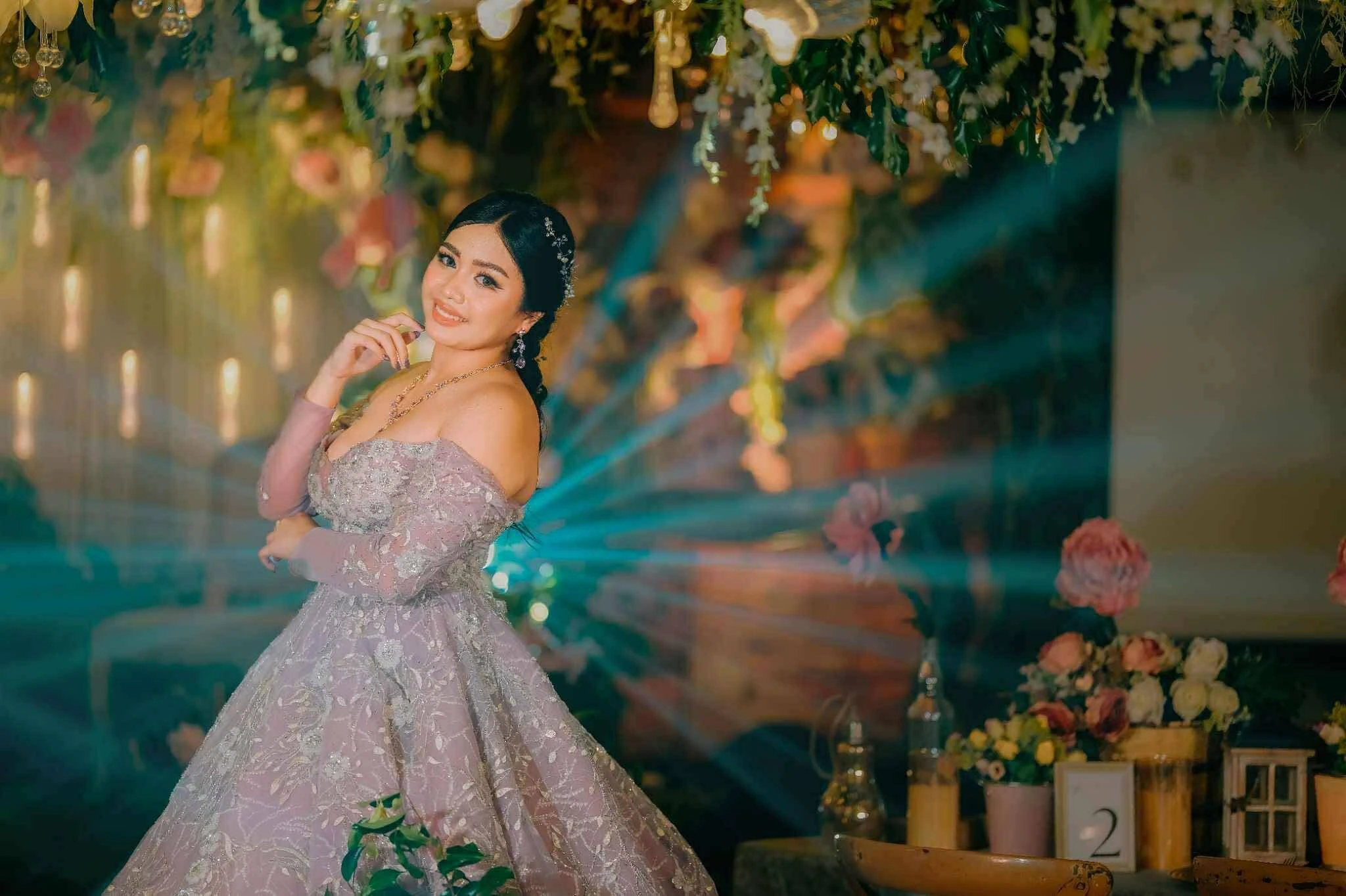 Debutante in a glamorous gown celebrating her 18th birthday with creative decorations and themed styling by an event planner.
