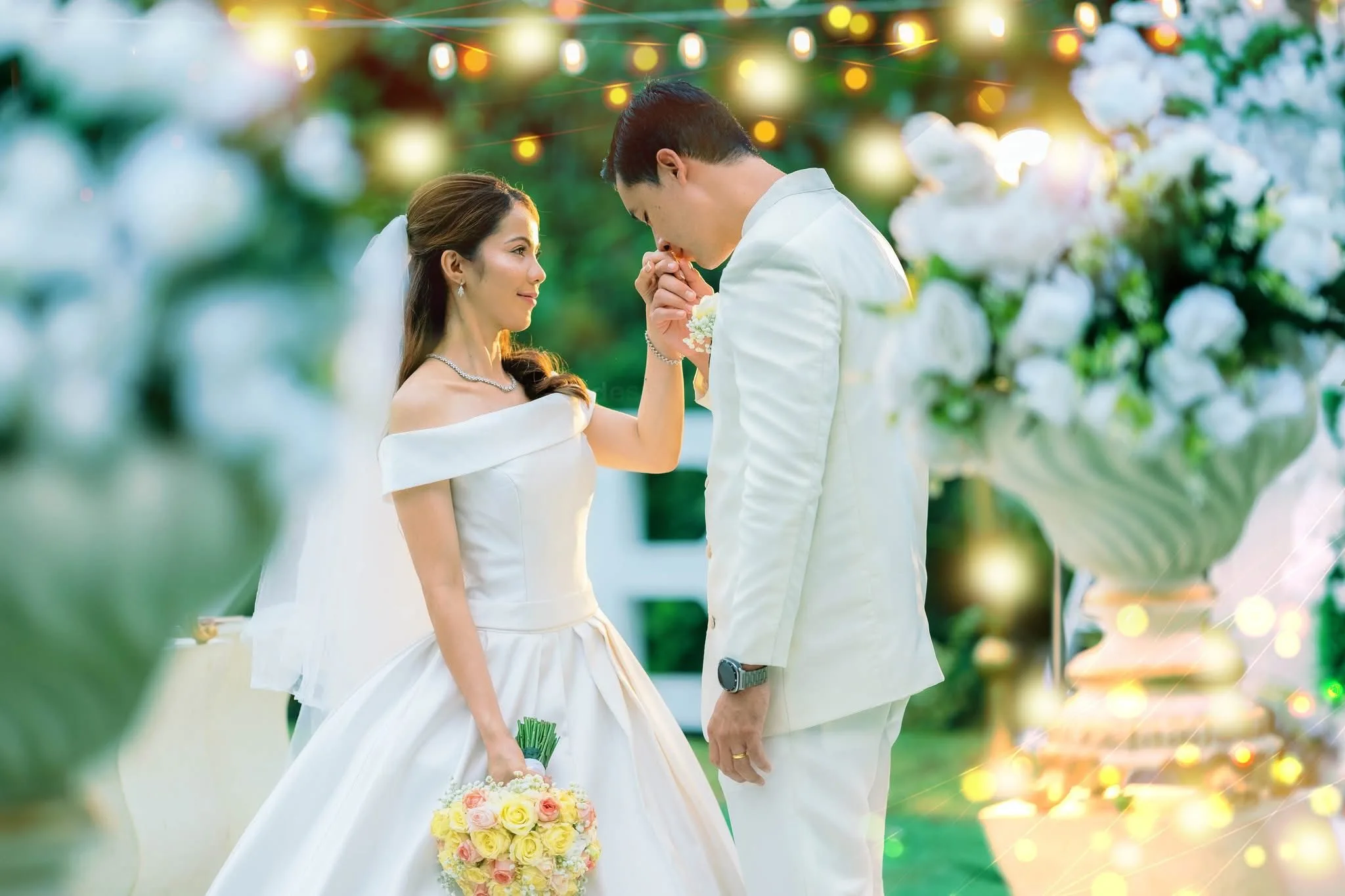 bride and groom just got maried kissing her hand